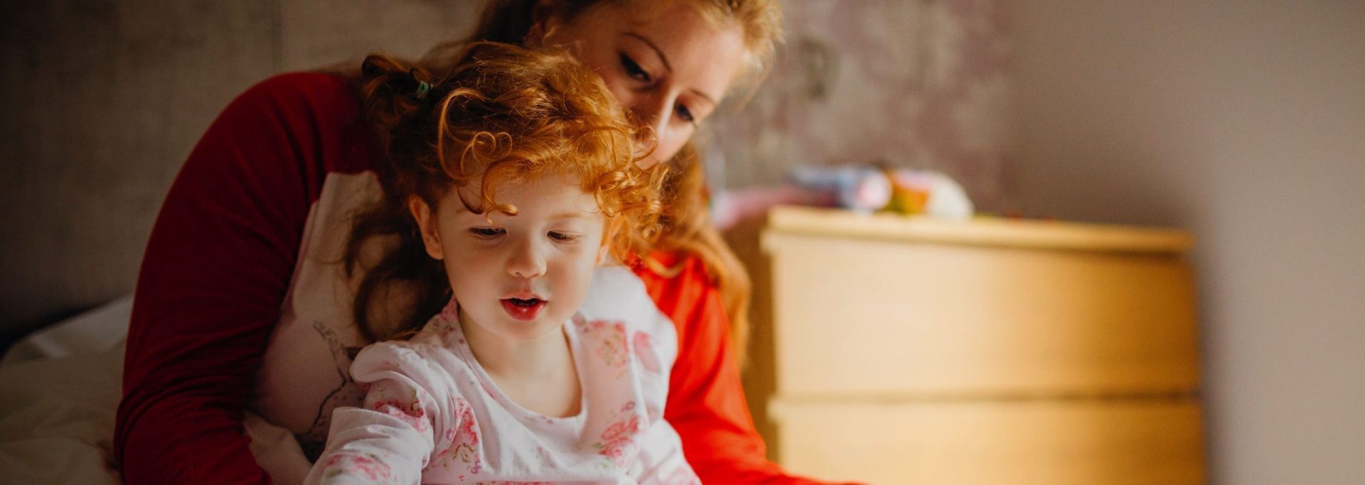 Homepage Hero Image | A mum with her daughter in her lap