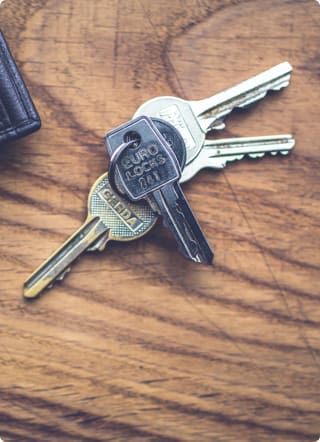 Secured loans for debt consolidation | A set of keys on a wooden surface
